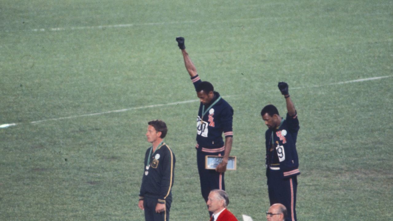 American sprinters Tommie Smith and John Carlos bow their heads and raise gloved fists in protest at the 1968 Olympics in Mexico City.