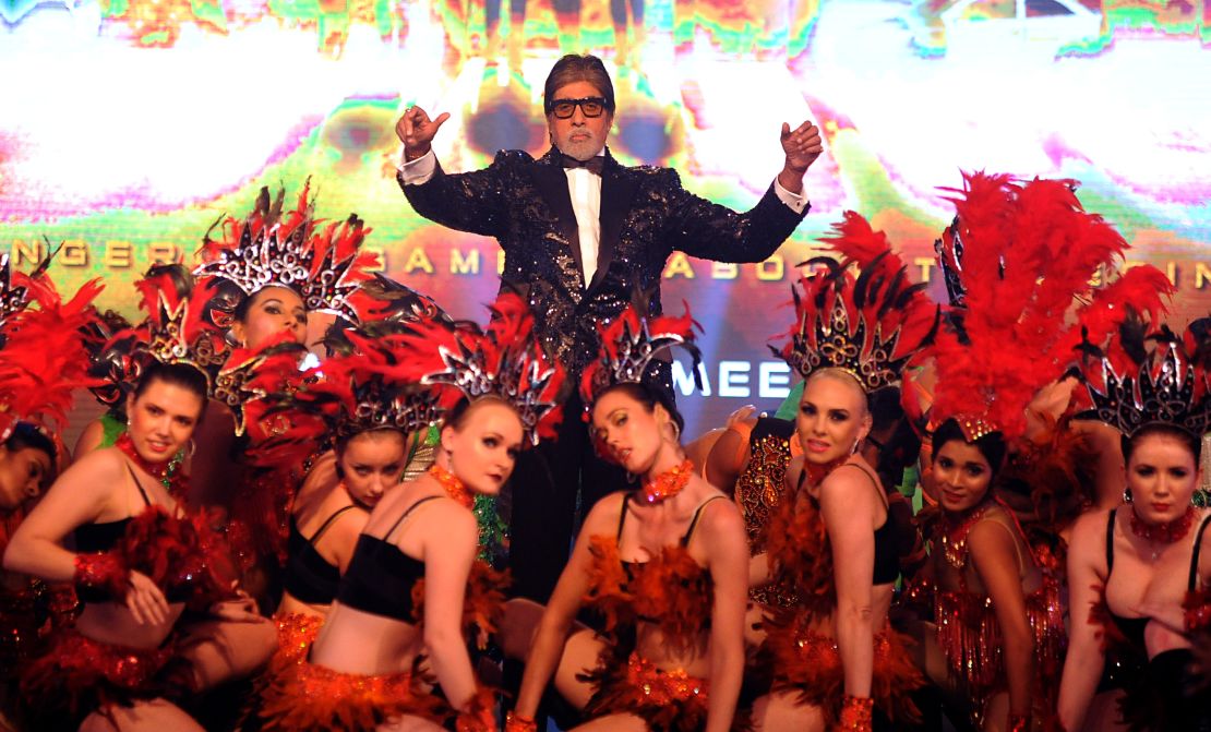Indian Bollywood actor Amitabh Bachchan poses with dancers earlier this year.