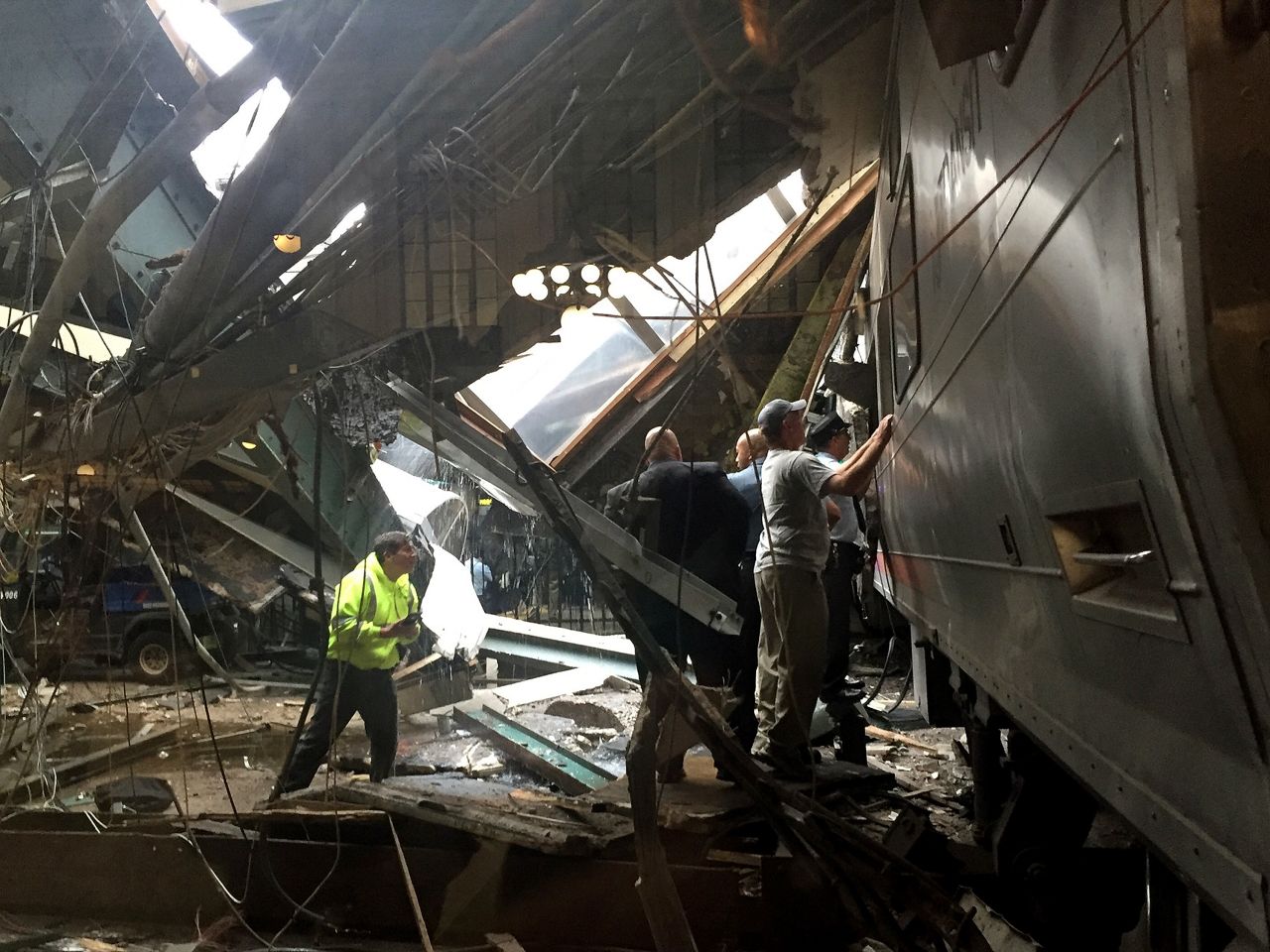 Emergency workers and others survey the train after the crash.