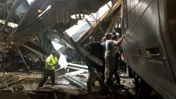 Train personel survey the NJ Transit train that crashed in to the platform at the Hoboken Terminal September 29, 2016 in Hoboken, New Jersey.