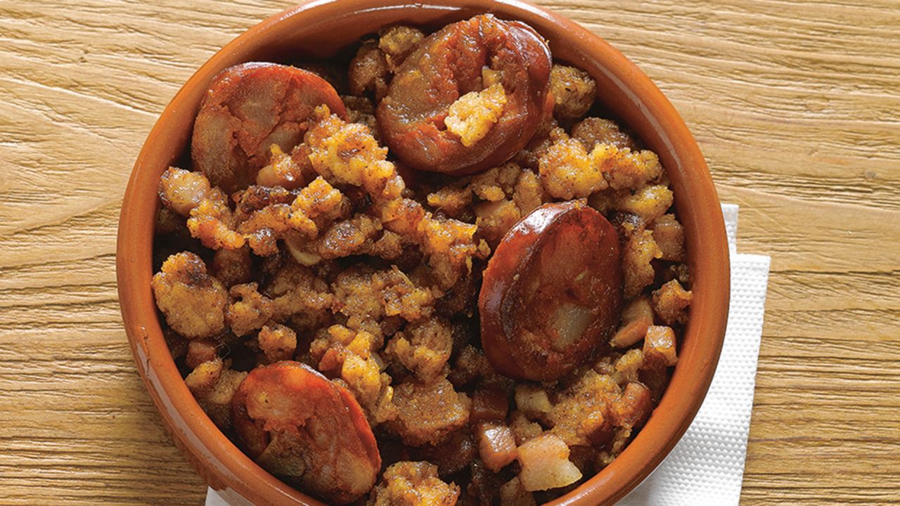 Migas, essentially dry breadcrumbs torn up and fried with ingredients like chorizo and bacon, has evolved from a peasant food to a dish served in fancy restaurants. It's the ultimate Spanish comfort food. (Image credit: "Quick & Easy Spanish Recipes" by Simone and Inés Ortega, Phaidon, <a href="http://phaidon.com" target="_blank" target="_blank">phaidon.com</a>)