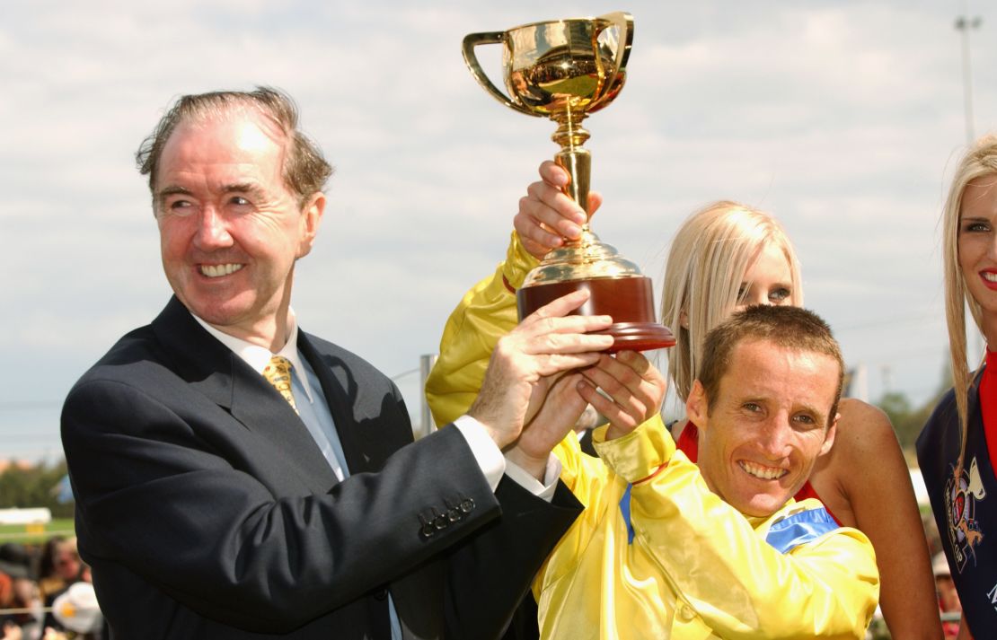 Dermot Weld and jockey Damien Oliver celebrate their 2002 Melbourne Cup victory.