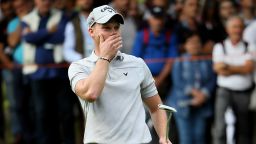 Danny Willett of England puts his hand over his mouth.