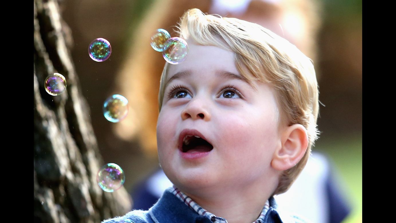 Britain's Prince George plays with bubbles at a children's party in Victoria, British Columbia, on Thursday, September 29. 