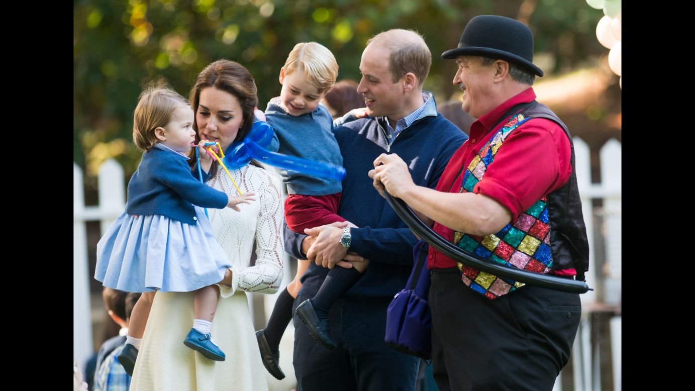The royal family, including Catherine, Duchess of Cambridge, interacts with a balloon artist during the party on September 29. 
