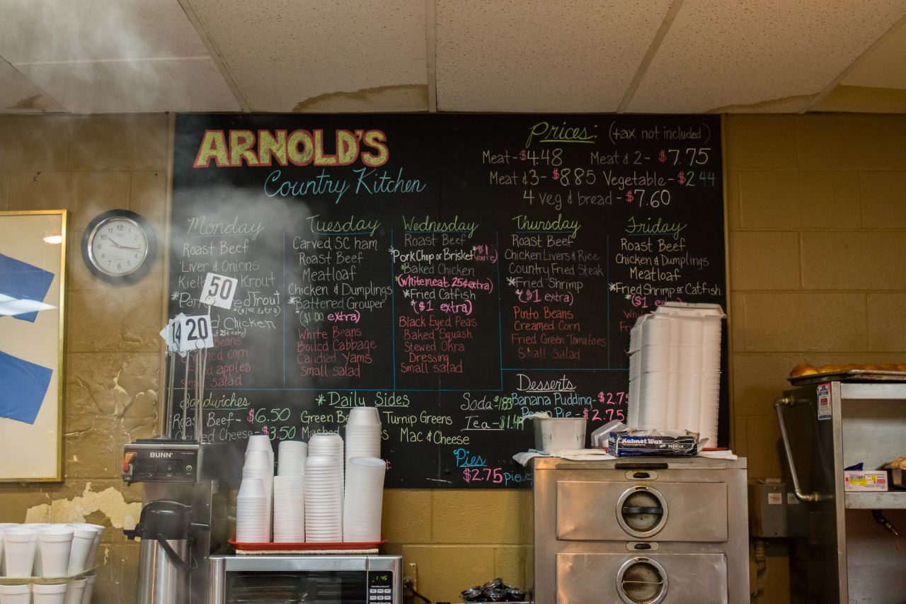 At Arnold's Country Kitchen, a blackboard features the day's choices. One meat with three sides is the formula for Nashville's traditional "meat-and-three" meal.