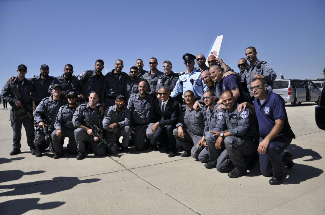 President Barack Obama poses for a photo with members of the Israeli police while in Jerusalem to deliver the eulogy at former Israeli Prime Minister Shimon Peres' funeral.