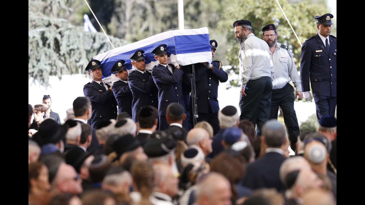 The flag-draped coffin arrives at Mount Herzl, where several eulogies were given by politicians and family.
