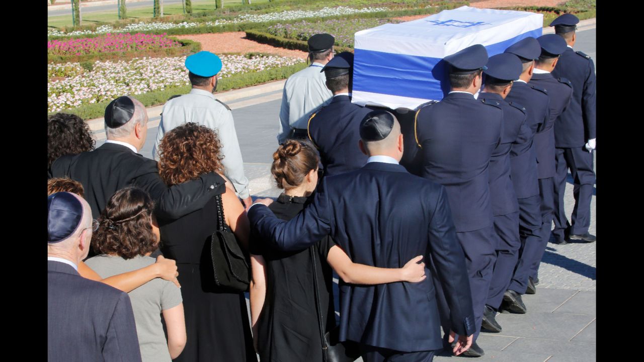 Family members walk behind Peres' coffin at the start of his funeral procession on September 30.