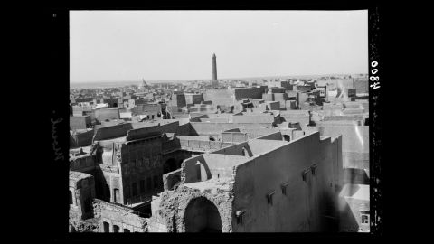 The famous leaning minaret of Mosul's 12th-century Great Mosque of al-Nuri towers in the background of this photo taken in the 1930s. 