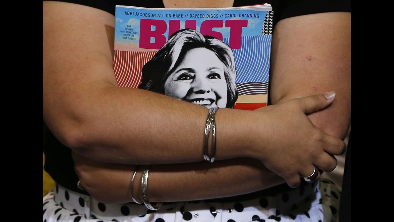 A woman holds a magazine with Hillary Clinton on the cover before the presidential candidate appeared at a campaign event in Durham, New Hampshire, on Wednesday, September 28.