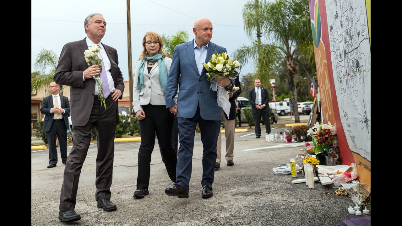 U.S. Sen. Tim Kaine, left, joins former U.S. Rep. Gabby Giffords and her husband, Mark Kelly, at a memorial site for victims of the <a href="http://www.cnn.com/interactive/2016/06/us/cnnphotos-orlando-portraits/" target="_blank">Pulse nightclub shooting</a> in Orlando. They made the visit on Monday, September 26 -- more than two months after the worst mass shooting in U.S. history.