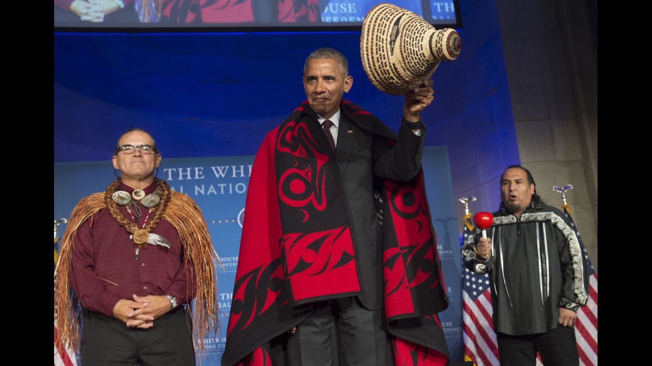 U.S. President Barack Obama wears a traditional blanket and hat given to him during the White House Tribal Nations Conference on Monday, September 26.