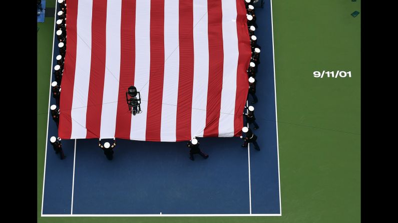 U.S. Marines unfurl a large American flag across New York's Arthur Ashe Stadium before the U.S. Open women's final on Saturday, September 10.