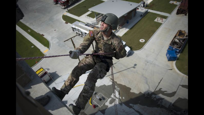 A member of the Oklahoma Air National Guard rappels down a building at a training center in Tulsa, Oklahoma, on Thursday, September 15.