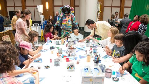The Hope suit is unveiled at MD Anderson as children work on artwork.