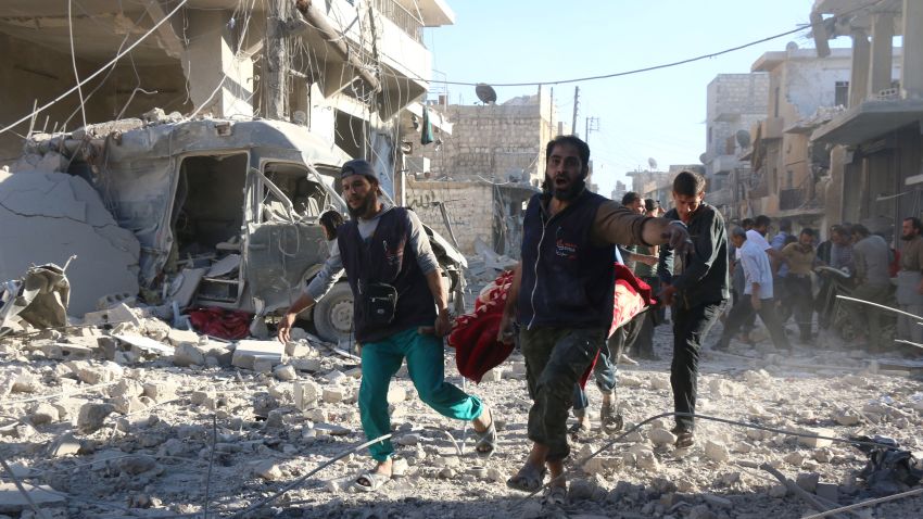 TOPSHOT - Syrian volunteers carry an injured person on a stretcher following Syrian government forces airstrikes on the rebel held neighbourhood of Heluk in Aleppo, on September 30, 2016.
Syrian regime forces advanced in the battleground city of Aleppo, backed by a Russian air campaign that a monitor said has killed more than 3,800 civilians in the past year. / AFP / THAER MOHAMMED        (Photo credit should read THAER MOHAMMED/AFP/Getty Images)