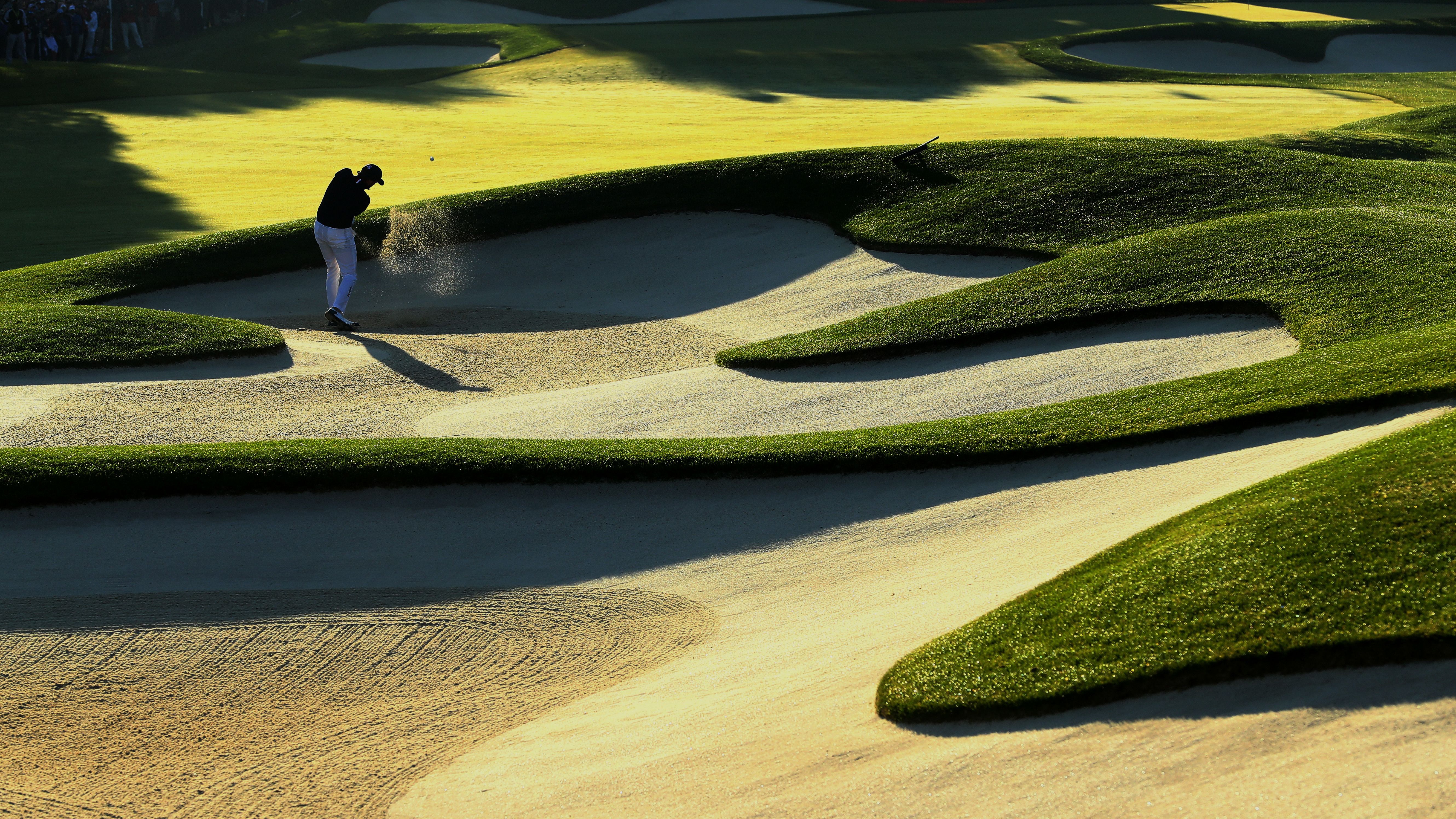 Jimmy Walker of the United States hits out of a bunker on the first hole.