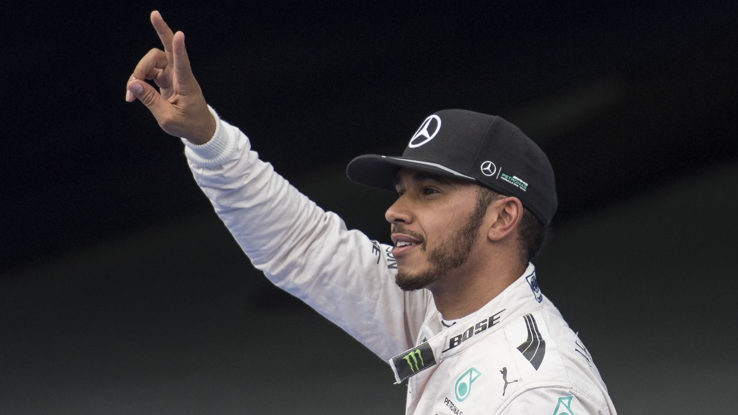 Lewis Hamilton gestures after taking pole position at the Malaysian Grand Prix.