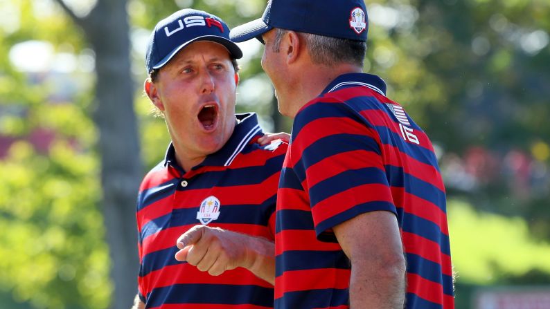 Phil Mickelson and Matt Kuchar of the United States react on the tenth green during afternoon fourball matches of the 2016 Ryder Cup at Hazeltine National Golf Club on October 1.