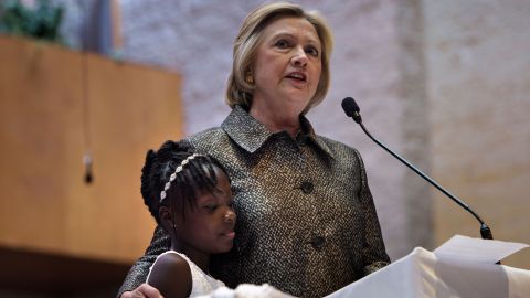 Hillary Clinton stands with Zianna Oliphant, 9, while speaking at Little Rock AME Zion Church in Charlotte, on Sunday.