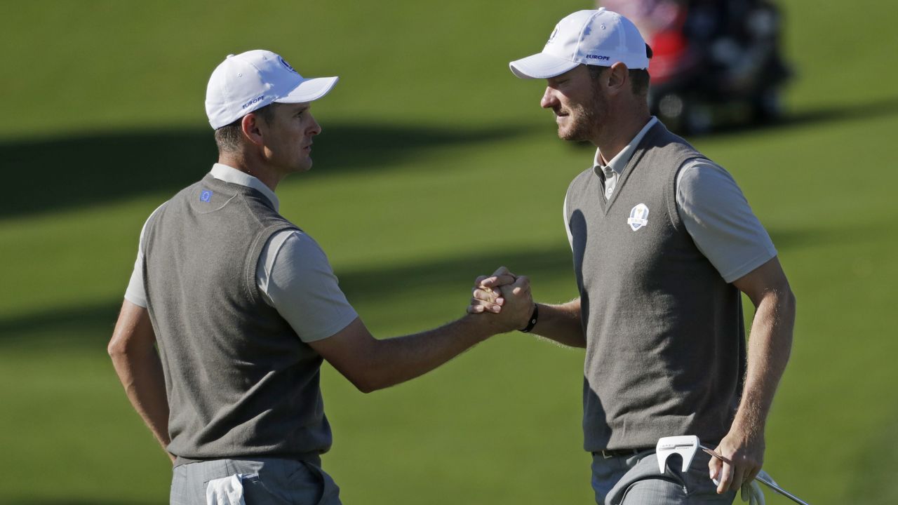 Justin Rose congratulates Chris Woods on his putt on the 10th hole, but both were to go down to final day defeats.