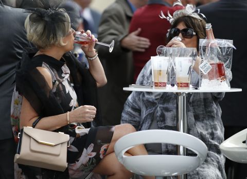 Racegoers enjoy a drink at Chantilly racecourse ahead of Europe's richest horse race. 