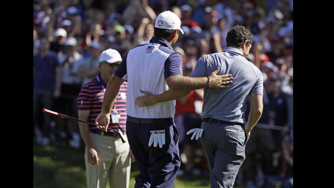 United States' Patrick Reed and Europe's Rory McIlroy walk off the eighth hole together during a singles match.