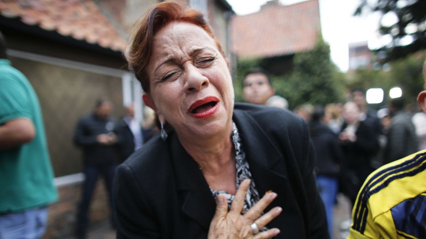An opponent to the peace deal celebrates after she listened to the results of the referendum to decide whether or not to support a peace accord in Bogota, Colombia.