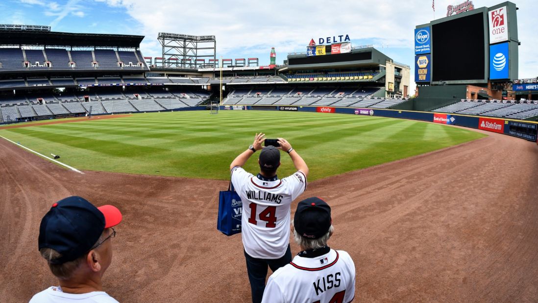 Brett Williams shoots a photo as he and Jim Kiss take a tour of Turner Field led by Bill Hardman, before the Braves' last baseball game there against the Detroit Tigers on Sunday, October 2, in Atlanta. The franchise is planning to start the 2017 season at SunTrust Park, which is under construction in Cobb County, north of Atlanta. 