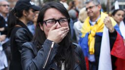 A supporter of the peace accord signed between the Colombian government and rebels of the Revolutionary Armed Forces of Colombia, FARC, cries as she follows on a giant screen the results of a referendum to decide whether or not to support the deal in Bogota, Colombia, Sunday, Oct. 2, 2016. Colombia's peace deal with leftist rebels was on the verge of collapsing in a national referendum Sunday, with those opposing the deal leading by a razor-thin margin with almost all votes counted.(AP Photo/Ariana Cubillos)
