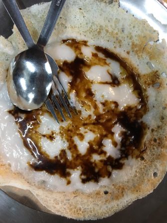 Palm sugar appam at Om Shakti Chelo's Appam Stall Bangsar. This traditional Indian breakfast pancake is made from fermented rice batter. It's soft in the middle, crispy around the edges and usually served with a hefty dose of coconut milk. 
