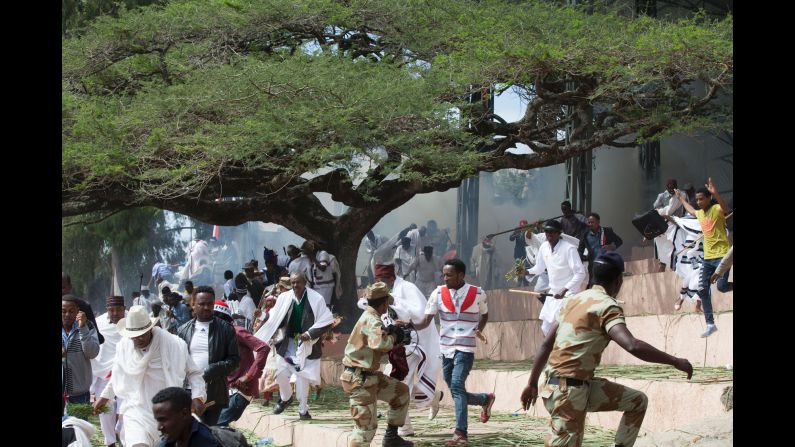 Festival goers flee as police fire teargas into the crowd in Bishoftu, near Addis Ababa, Ethiopia, on Sunday, October 2. At least 52 people died during the stampede that followed. An estimated two million people had gathered at a sacred lake to take part in the Irreecha ceremony to mark the Oromo New Year.