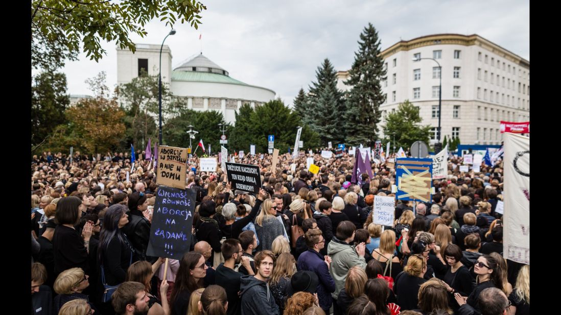 A crowd gathers outside the parliament building in the Polish capital on Saturday as part of the concern over the proposed legislation.
