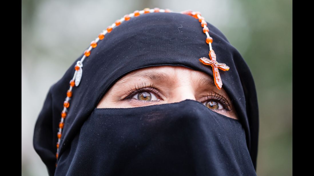 A woman with rosary beads around her head attends an earlier pro-choice demonstration in front of the Polish parliament in Warsaw, Poland on Saturday.