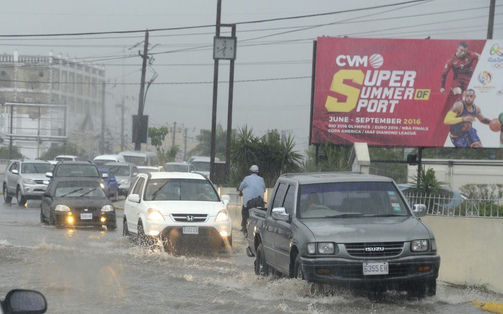 Motorists drive through heavy rains in Kingston, Jamaica, on October 2.