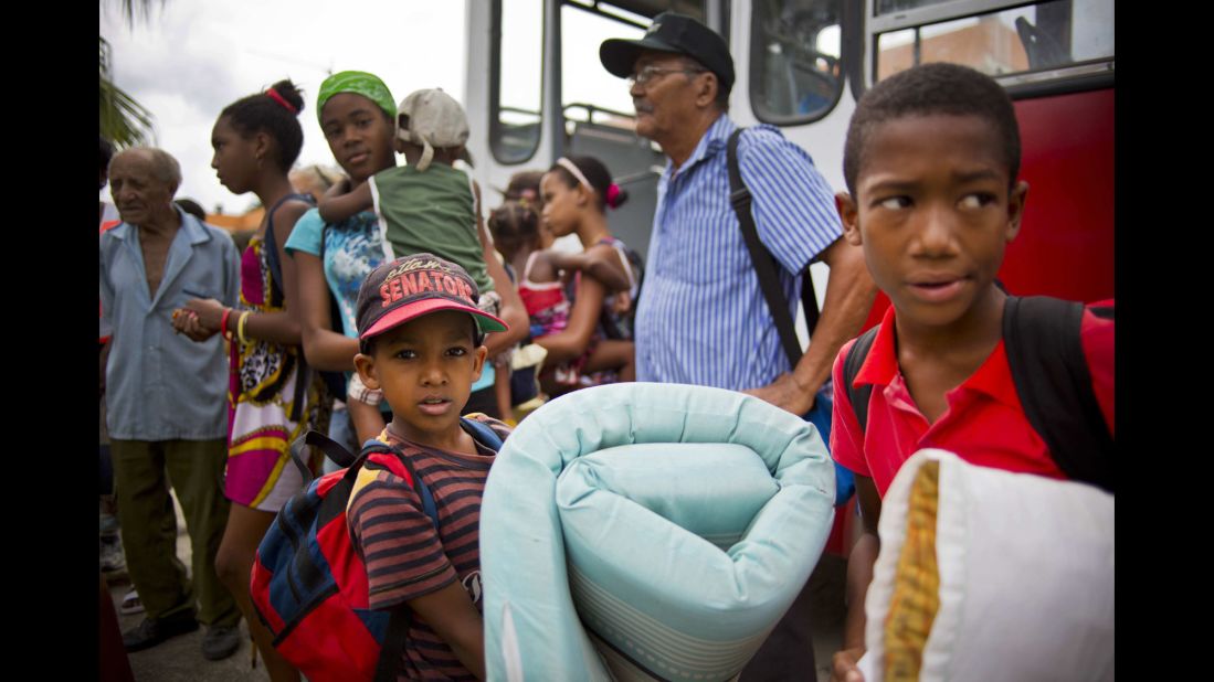 Families seek shelter from Hurricane Matthew at a university facility in Guantanamo, Cuba.