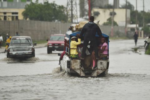 A truck used as public transportation drives through flooded streets in Port-au-Prince on October 4.