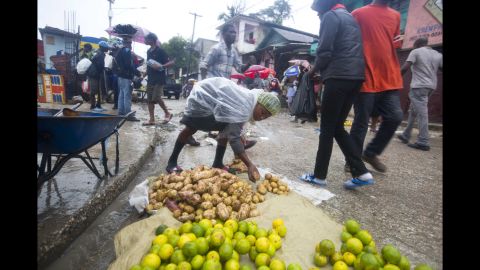 A food vendor lays out goods for sale during a light rain in Port-au-Prince on October 4.