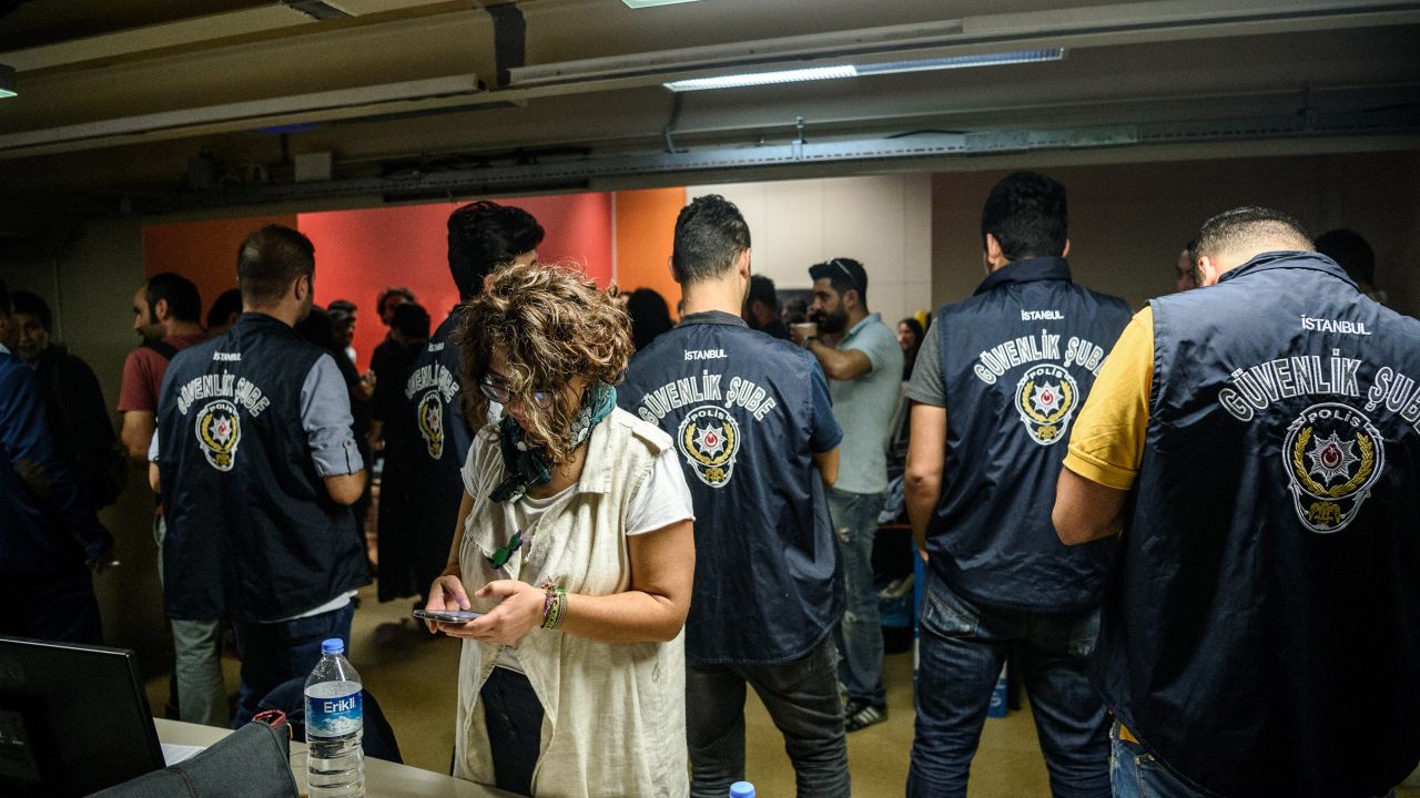 Turkish police officers in the offices of IMC TV station during a raid on October 4, 2016 in Istanbul.