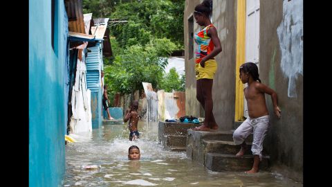 Children swim in a flooded neighborhood of Santo Domingo on October 4. 