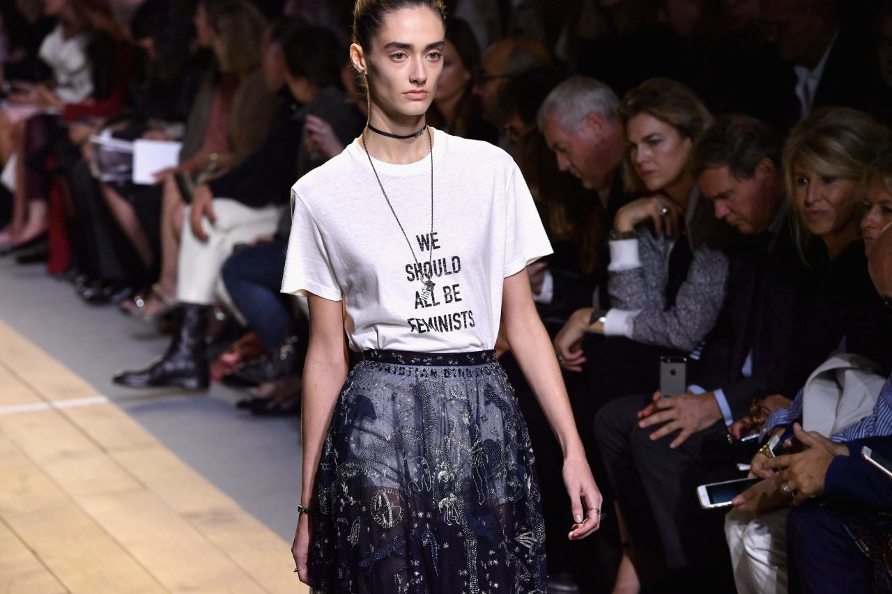 A model walks the runway wearing a "we should all be feminists" shirt in a recent Dior show.