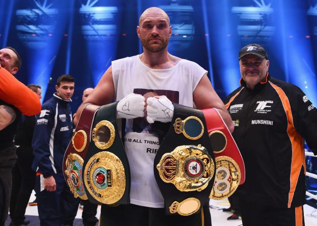 Tyson Fury celebrates with his belts after beating Wladimir Klitschko to become new world heavyweight champion.