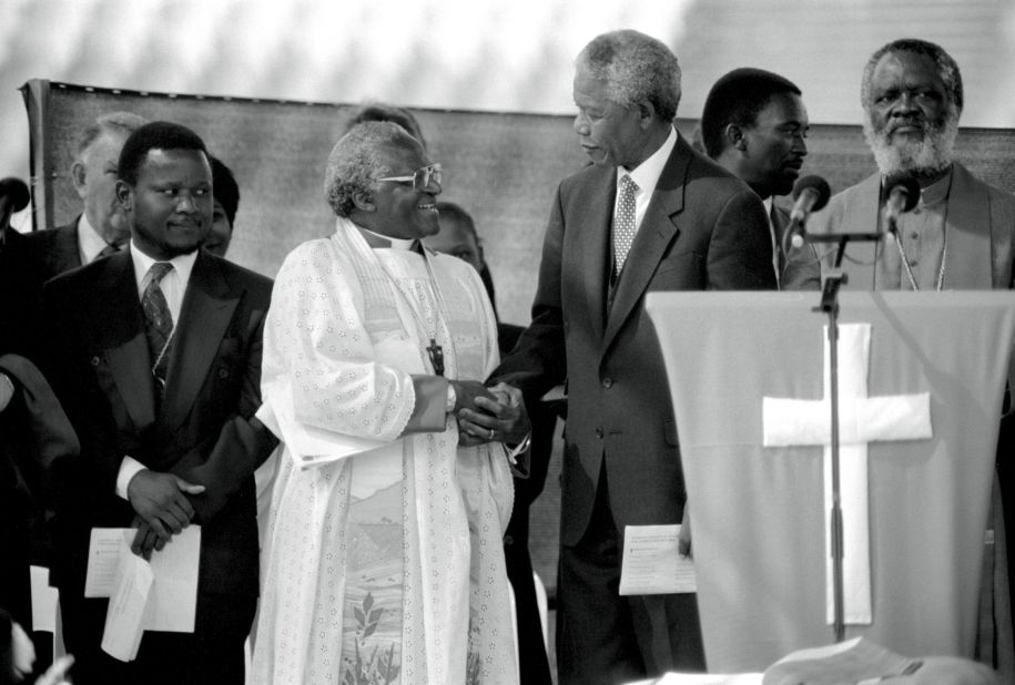 Tutu greets Mandela at a rally, weeks before South Africa's historic democratic election in 1994.