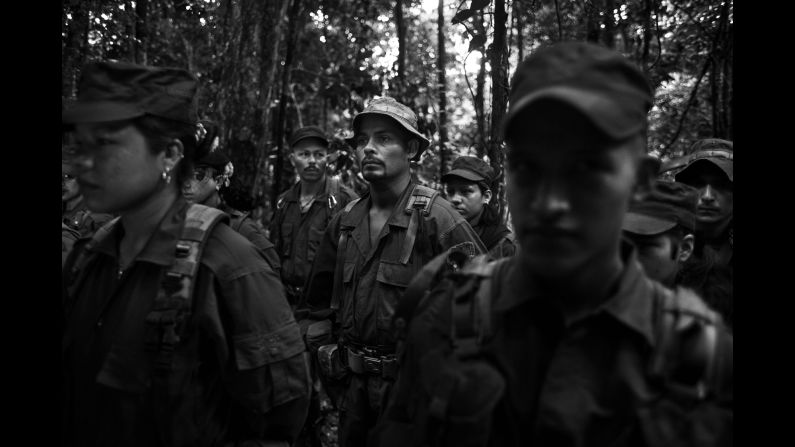 The morning call is issued at 4:30 a.m. for members of a FARC camp in Colombia's Meta Department. After an exercise session, the rebels sing the organization's hymn and their commander reads them the important news of the day. Photographer Fabio Cuttica spent time with the guerrillas in November.