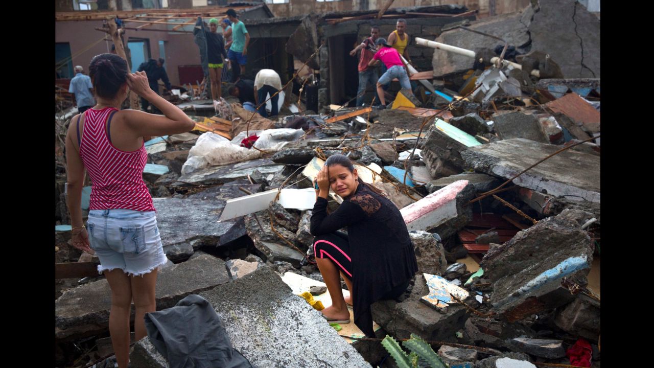 A woman cries amid the rubble of her home in Baracoa.