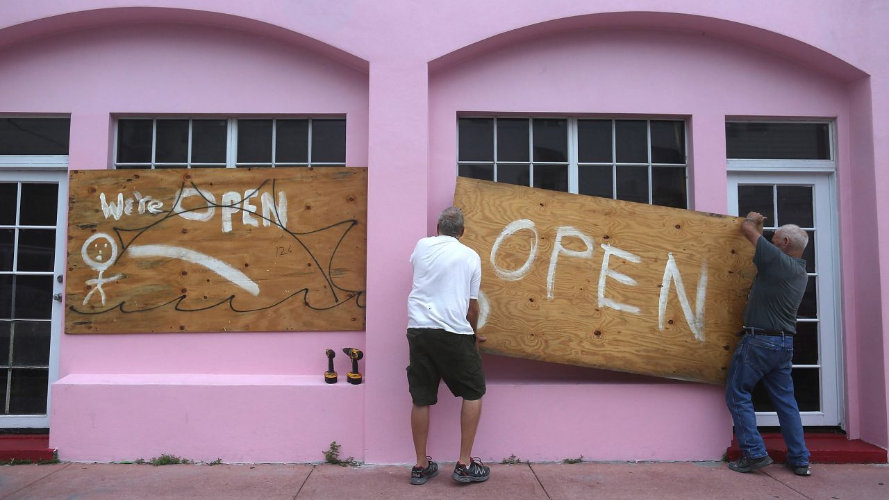 Kevin Forde and John Haughey put plywood on a Miami Beach window on October 6.