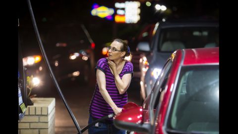 Beth Johnson fills up her car at a gas station in Mt. Pleasant, South Carolina, on October 4.