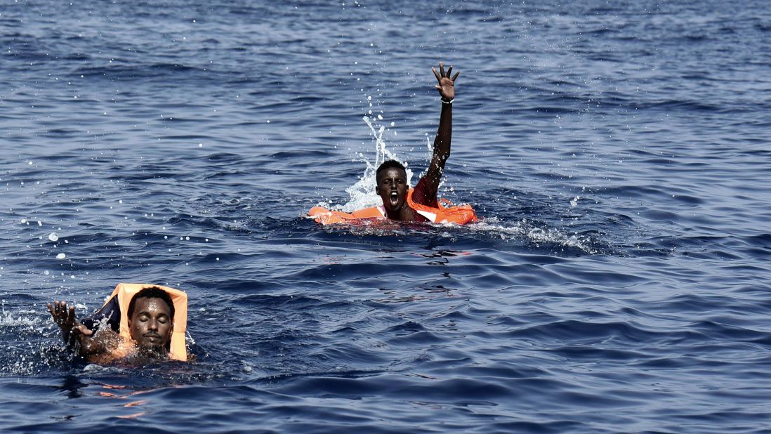 Migrants swim toward a rescue boat manned by the Spanish NGO Proactiva Open Arms in the Mediterranean Sea off the coast of Libya on Tuesday, October 4.