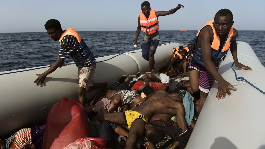 Migrants step over dead bodies while being rescued in the Mediterranean Sea.